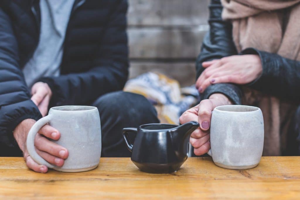 2 people having a cup of tea