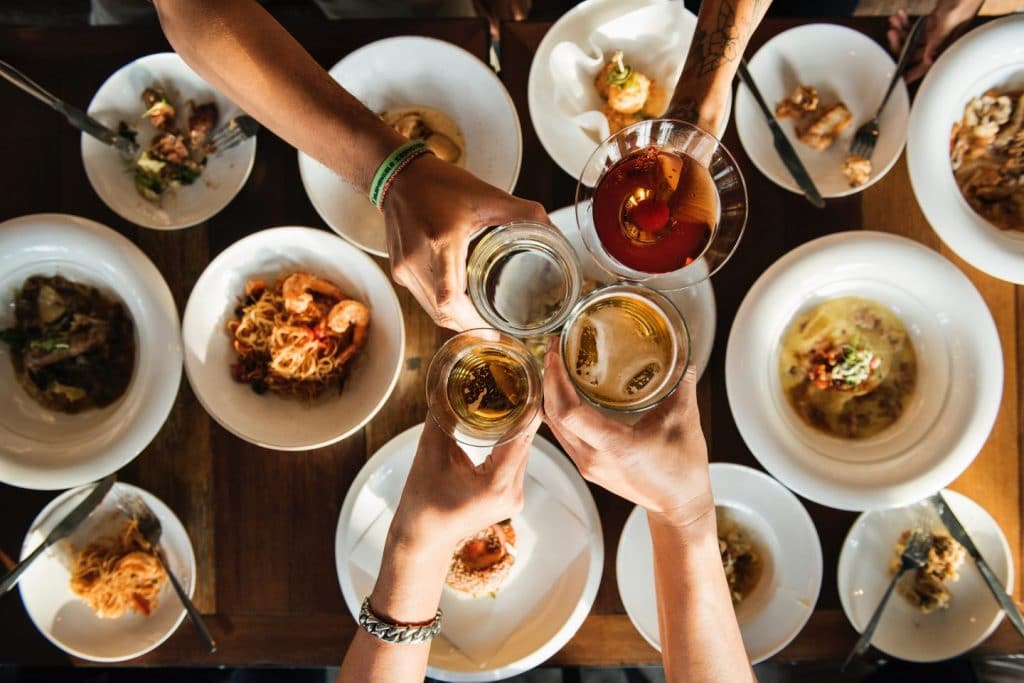 team toast at dinner table